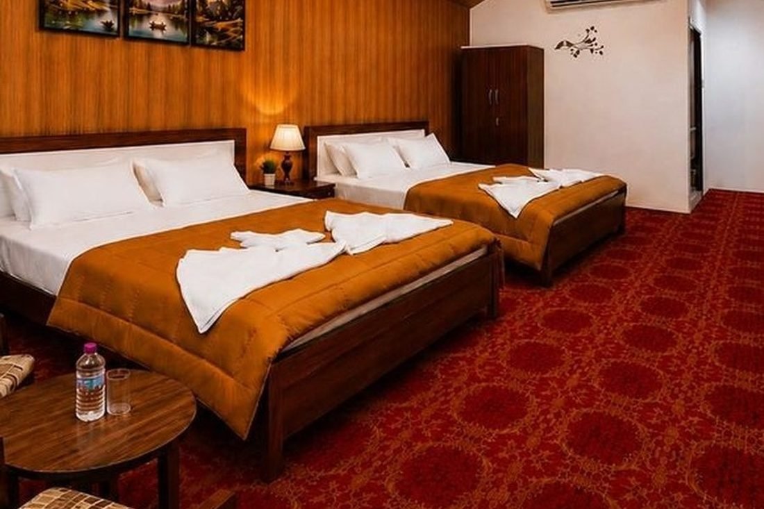 Twin-bed tent city room interior with folk wall art